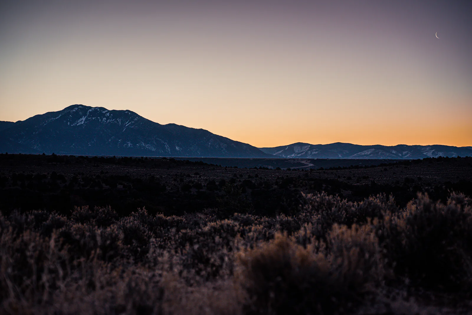 First light over the Sangre de Cristo mountains, with sagebrush in the foreground